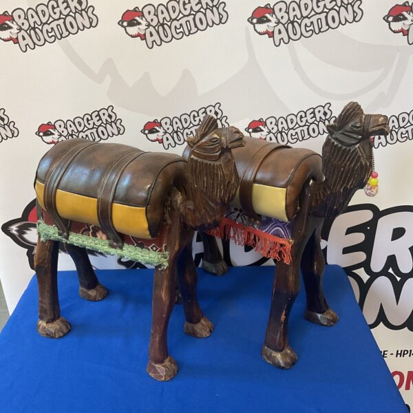 Pair of vintage wooden camel footstools with leather detailing.