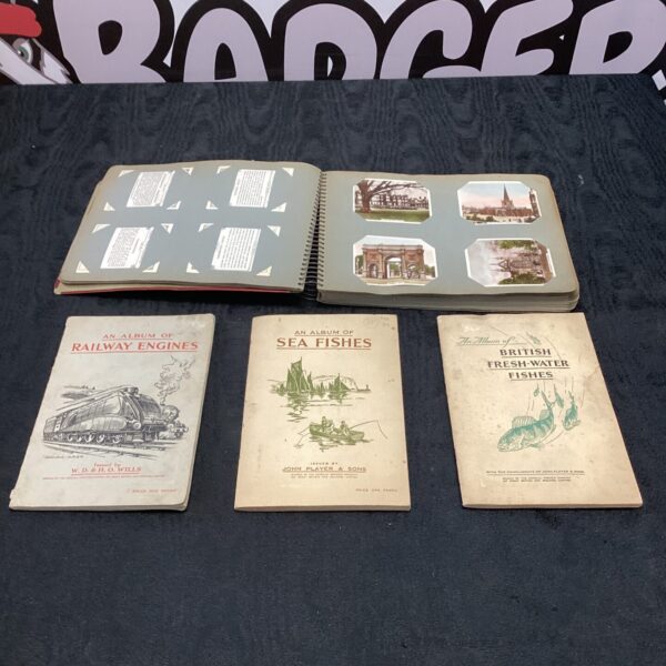 Group of vintage cigarette card albums, including railway and sea themes.