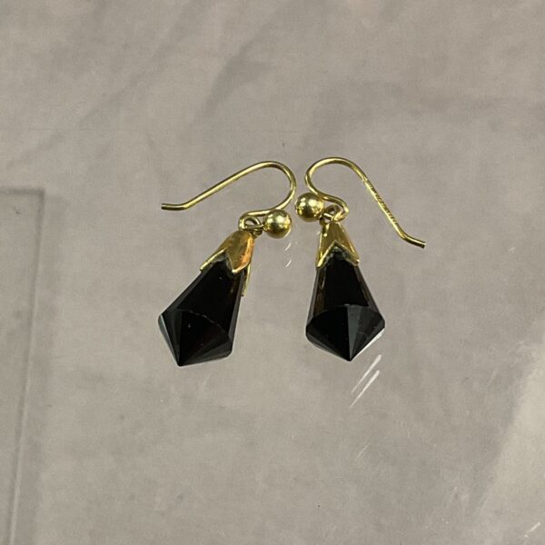 Elegant 9ct gold drop earrings with dark coloured stones.