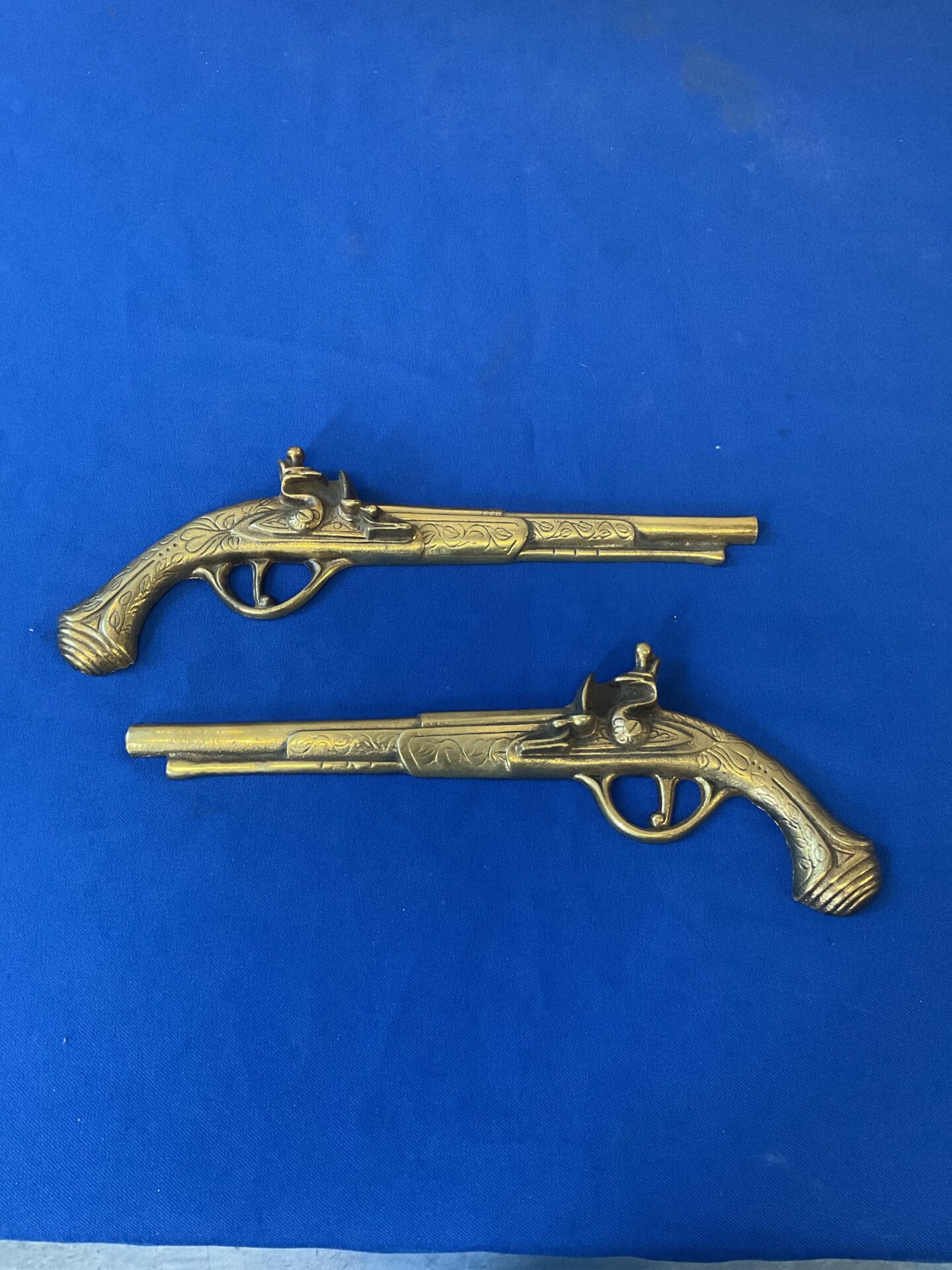 025 Pair of brass wall hanging pistols