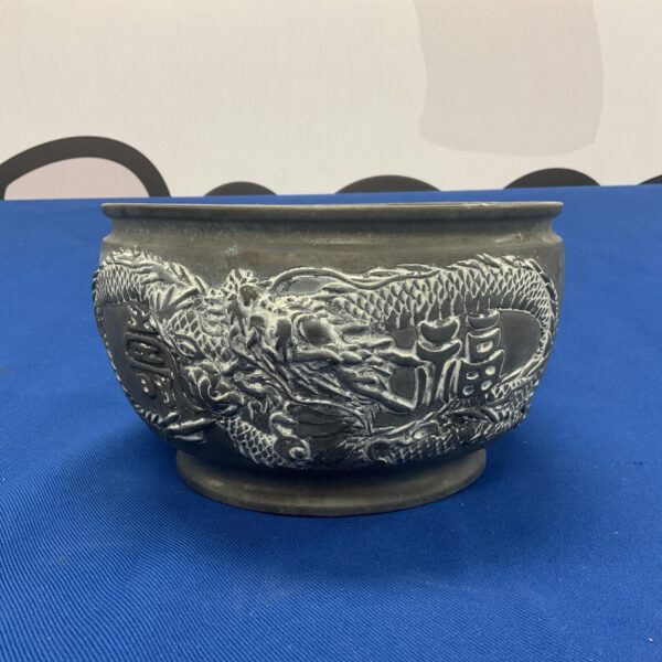 Antique Chinese dragon bowl with detailed bronze relief.