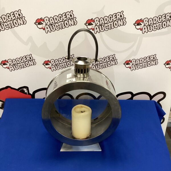 Modern stainless steel and glass candle lantern for warm lighting.