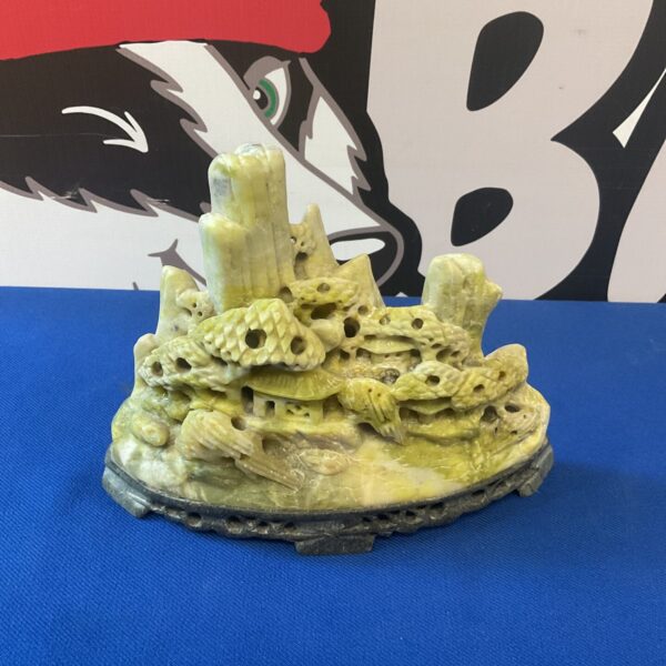 Detailed Chinese jadeite sculpture of a mountain landscape.