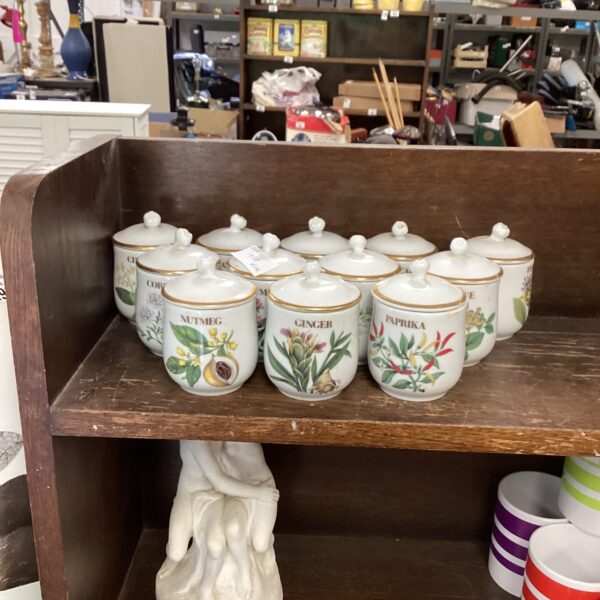 Vintage Royal Worcester spice jars displayed on a shelf.