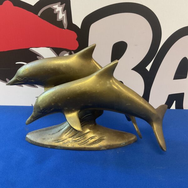Vintage brass dolphin ornament sculpture for nautical decor.