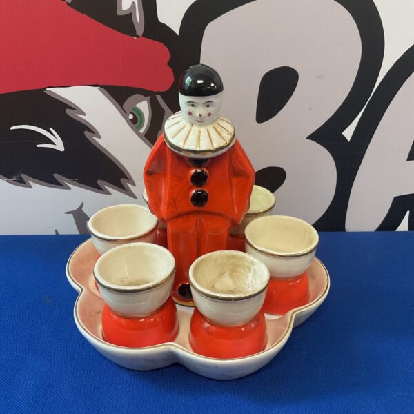 Vintage art deco clown egg holder set with four egg cups.