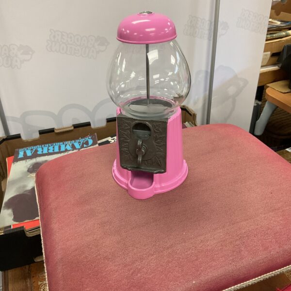 Vintage gumball machine with clear glass dome and metal base.