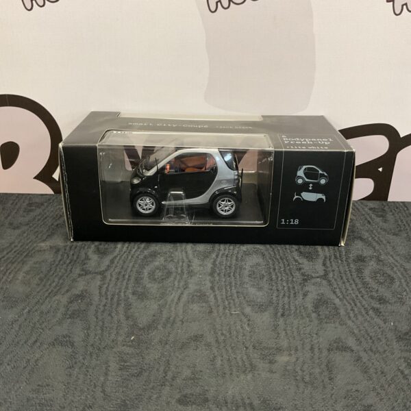 Detailed diecast model of a smart city coupe car.