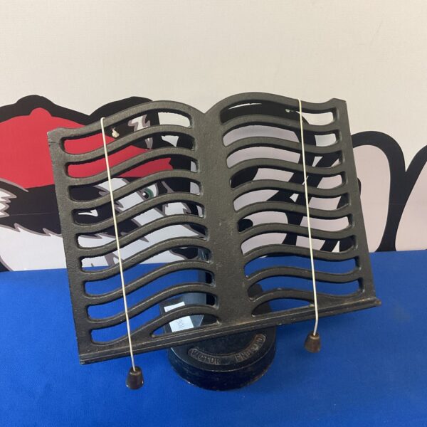 Antique cast iron cookbook stand with Victorian design for recipes.