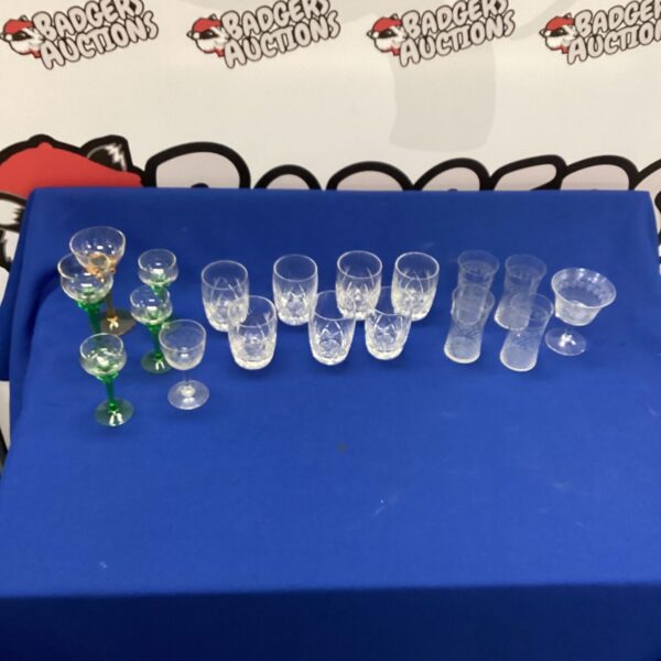 Selection of colourful vintage crystal glasses on display.