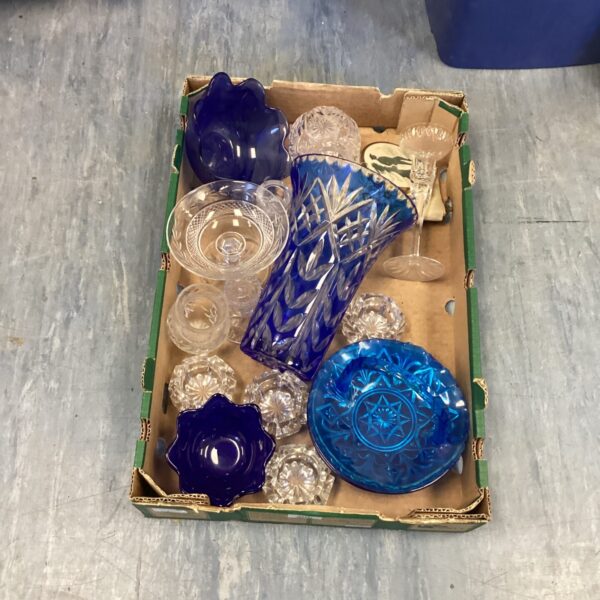 Mixed glassware lot with a striking blue vase on display.