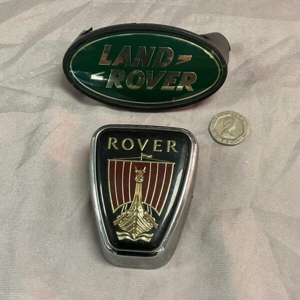 Vintage Land Rover badge with green and yellow emblem.