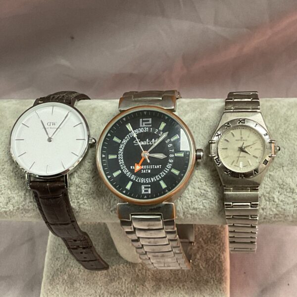 Silver and black vintage wristwatch with leather strap.