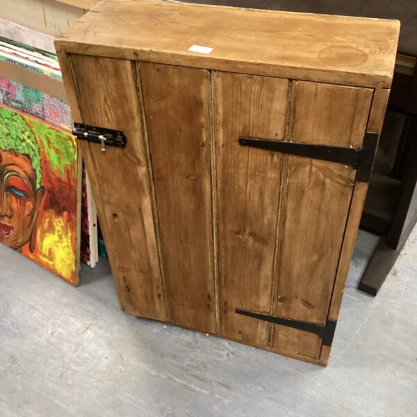Weathered rustic pine cabinet with a single door.