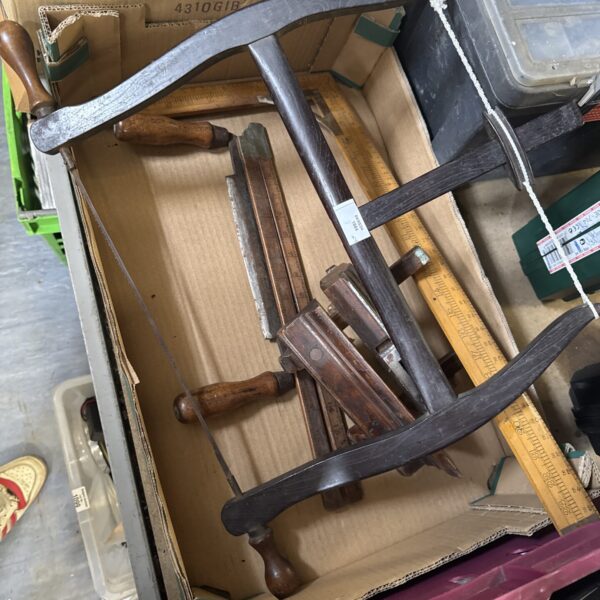 Vintage woodworking tools lot including hand planes and chisels.