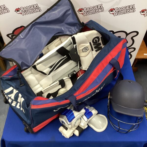 Infinity cricket kit bag with GM branding and cricket equipment.