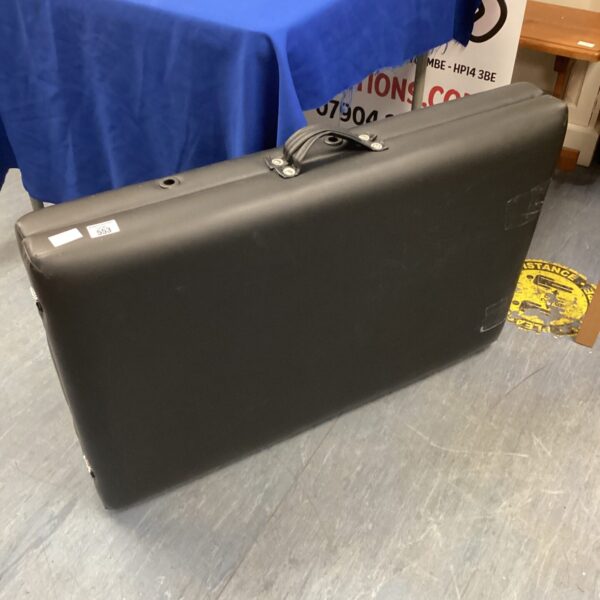 Black folding massage table HP14, showing wear and tear.
