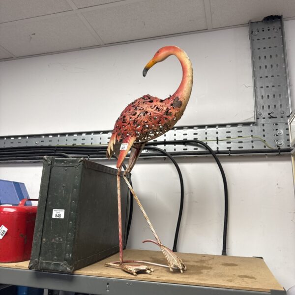 Decorative metal flamingo ornament for garden display.