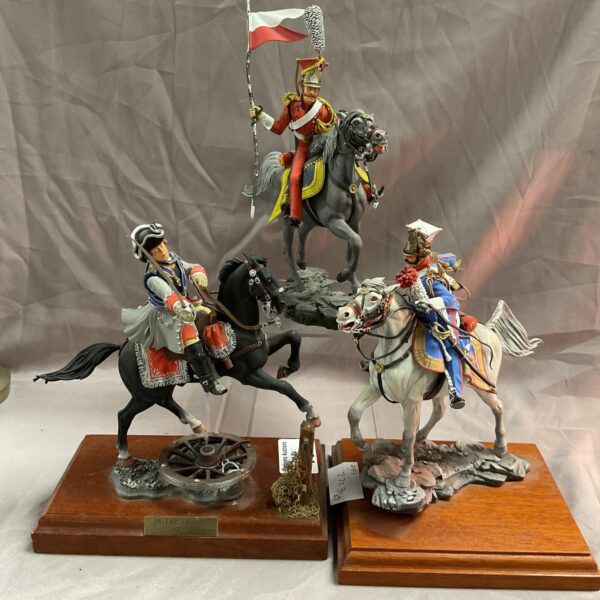 Set of three vintage Napoleonic French pewter soldiers on display.