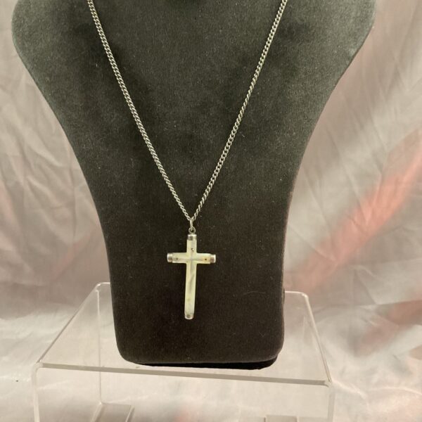 Vintage mother of pearl cross pendant on a 22 inch necklace.