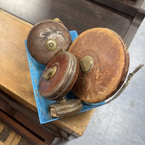 Lot of four vintage tape measures, including a Chesterman.