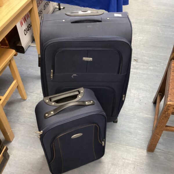 Two wheeled travel suitcases with extending handles, ready for travel.