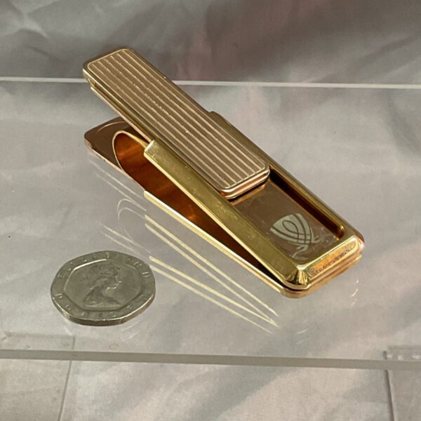 Silver M-Clip money clip for holding cash and cards.