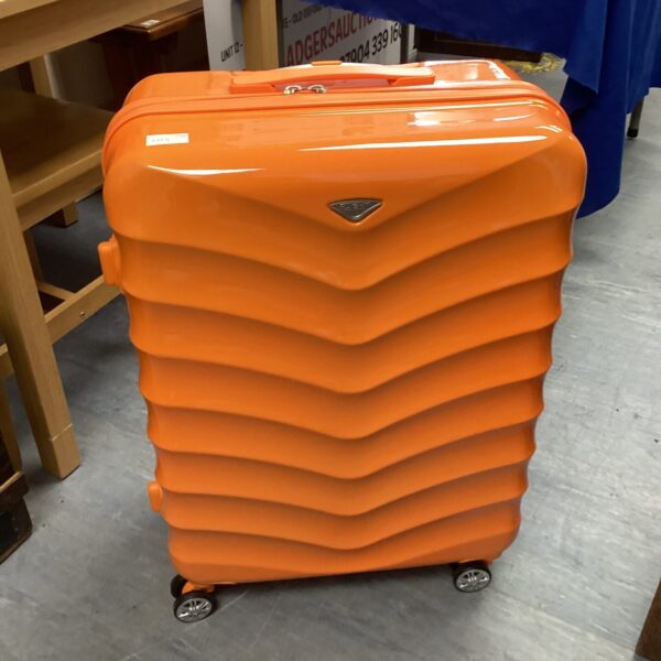 Bright orange Flight Knight suitcase with extendable handle.