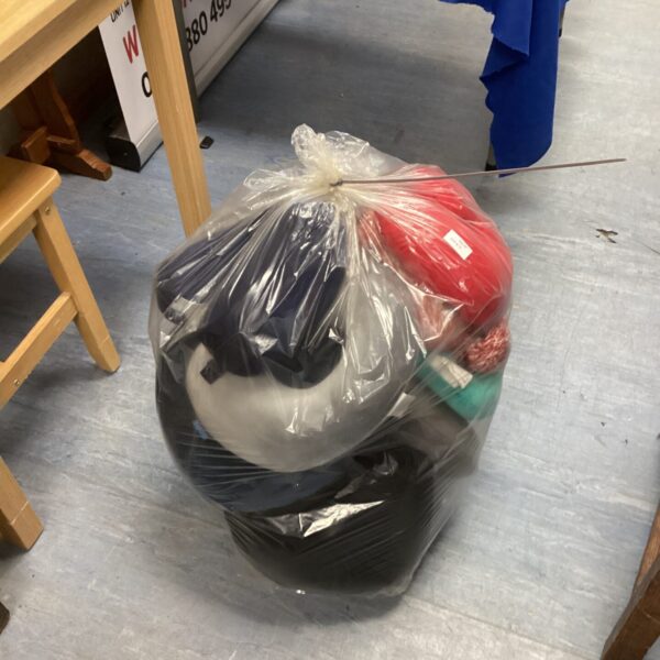 Sealed plastic bag containing a lot of travel cushions for comfort.