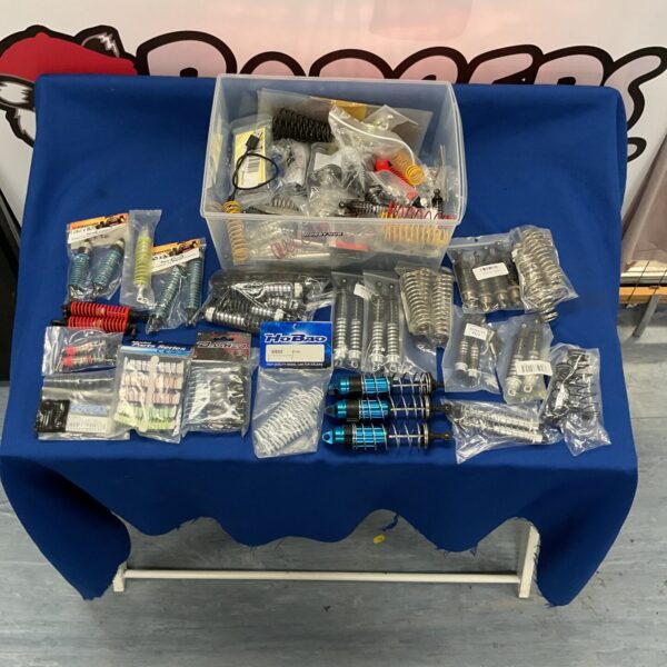 New RC car parts and accessories lot with springs and shocks.