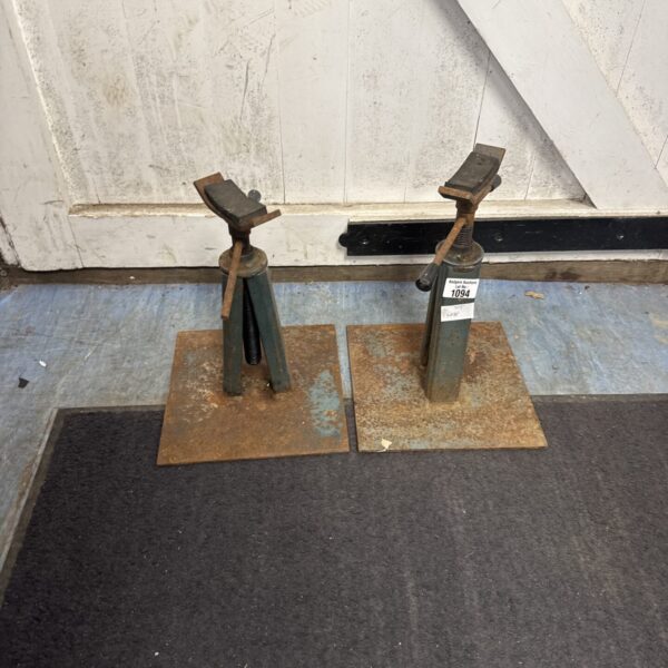 Pair of vintage metal axle stands for automotive repair.