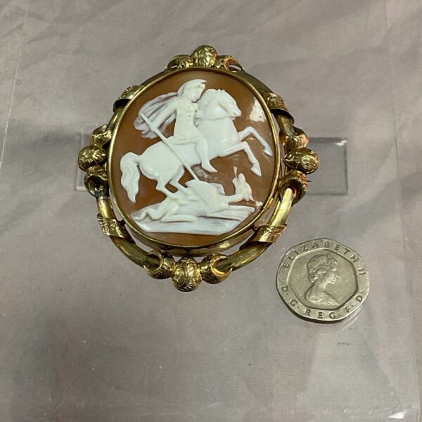 Antique yellow metal St George cameo pendant with dragon carving.