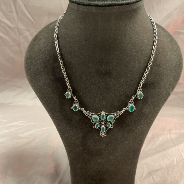 Elegant Art Nouveau silver necklace with green stones.