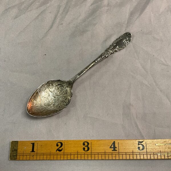 Antique Edwardian silver jam spoon with floral design.