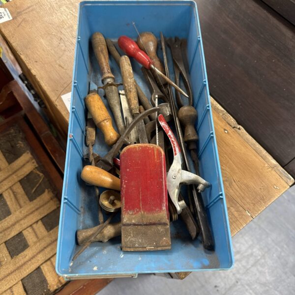Vintage hand tool tray with assorted workshop implements.