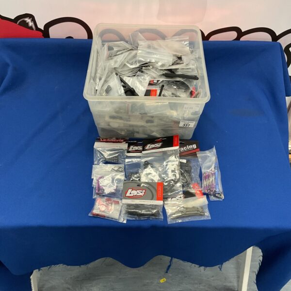 New RC model parts lot with wheels and tires.