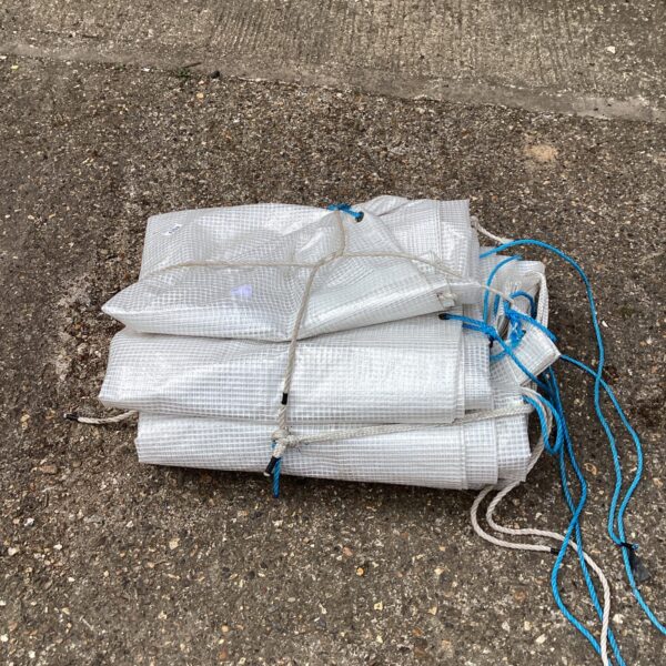 Folded lengths of heavy-duty plastic sheeting for garden or DIY projects.