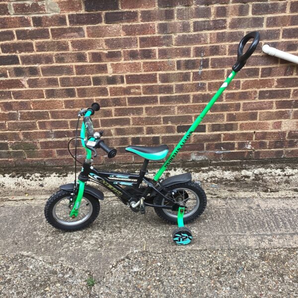 Black and green Hero childs bike with parental control bar.