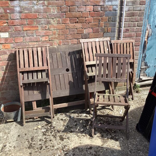 Vintage hardwood garden table and four chairs in a garden setting.