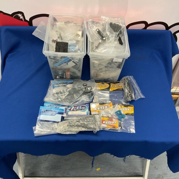 New RC car parts and accessories from HSP and Hobao in boxes.