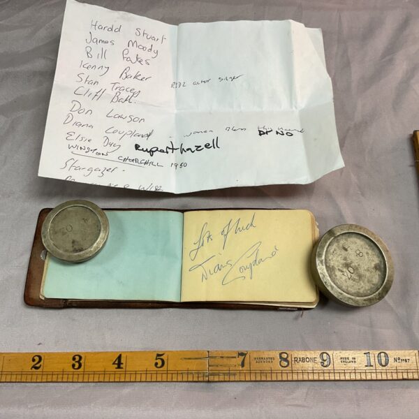 Vintage autograph book with celebrity signatures, including Bert Weldon and Diana Copeland.