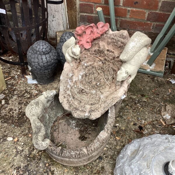 Charming garden squirrel water feature with tiered design.