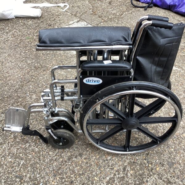 Side view of a used Drive folding wheelchair, a mobility aid.