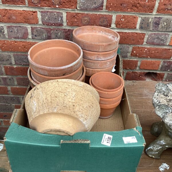 Stack of vintage terracotta flower pots for garden plants.
