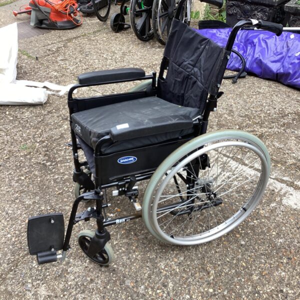 Used Invacare folding wheelchair with a padded seat cushion.