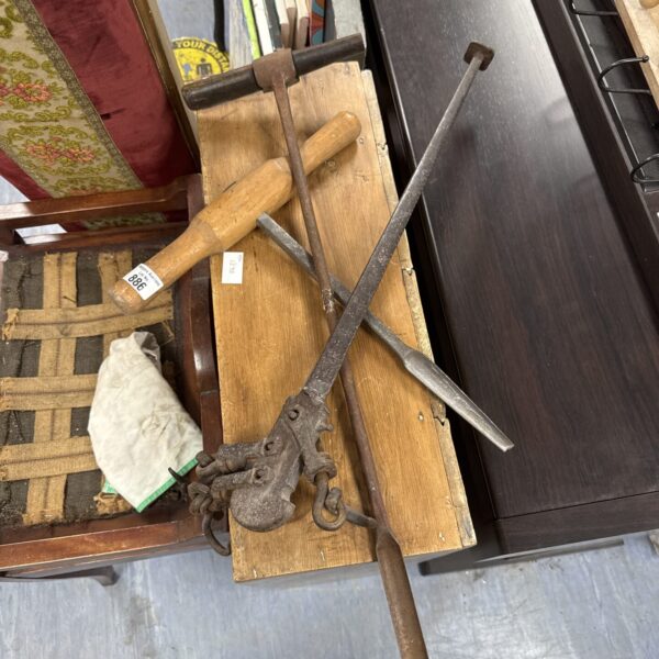Two vintage hole boring augers displayed on a wooden surface.