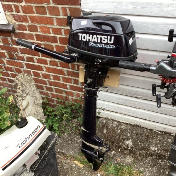 Tohatsu four stroke outboard motor with tiller handle.