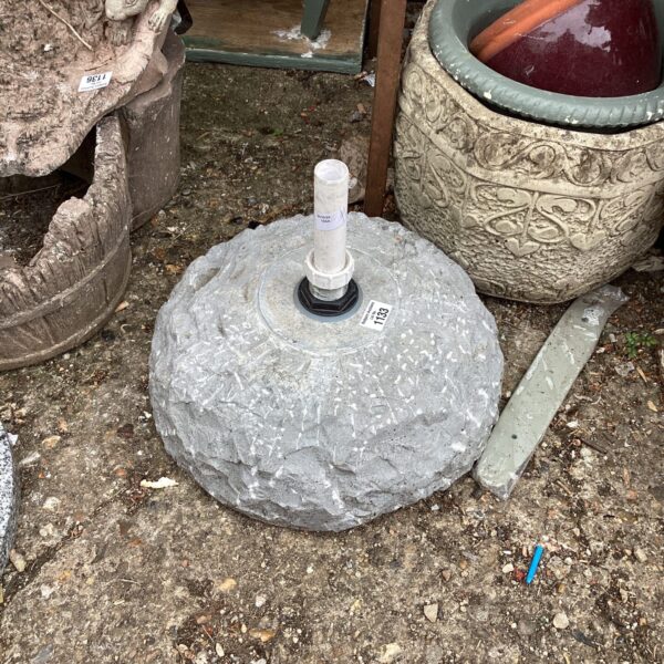 Heavy stone effect garden parasol base for outdoor use.