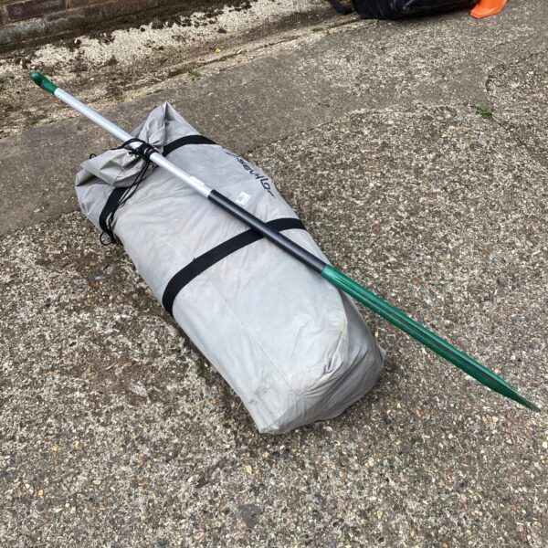 Rolled Sevylor inflatable kayak and paddle ready for water sports.