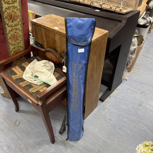 Blue canvas case containing a set of drain rods for plumbing.